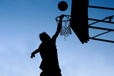silhouette of a man playing basketball