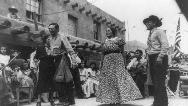 black and white photo of dancers dancing in the street