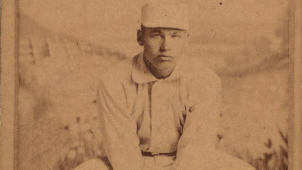 sepia-toned image of a seated William Hoy from a baseball card