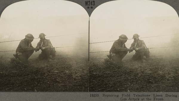 sepia-toned stereoscopic image of two soldiers repairing a phone line while wearing gas masks