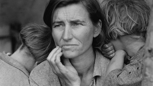 black and white close-up photo of a woman holding two children