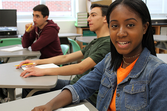 Wide shot of Jasmine at a desk