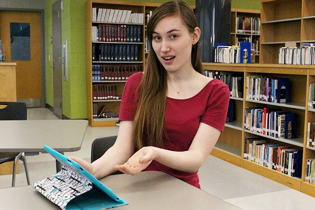 Zoe holding a tablet