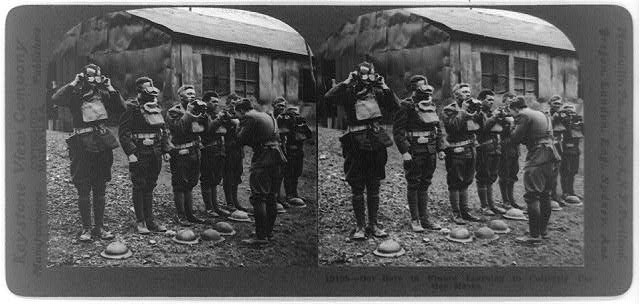 steroscopic black and white photograph of soldiers wearing gas masks