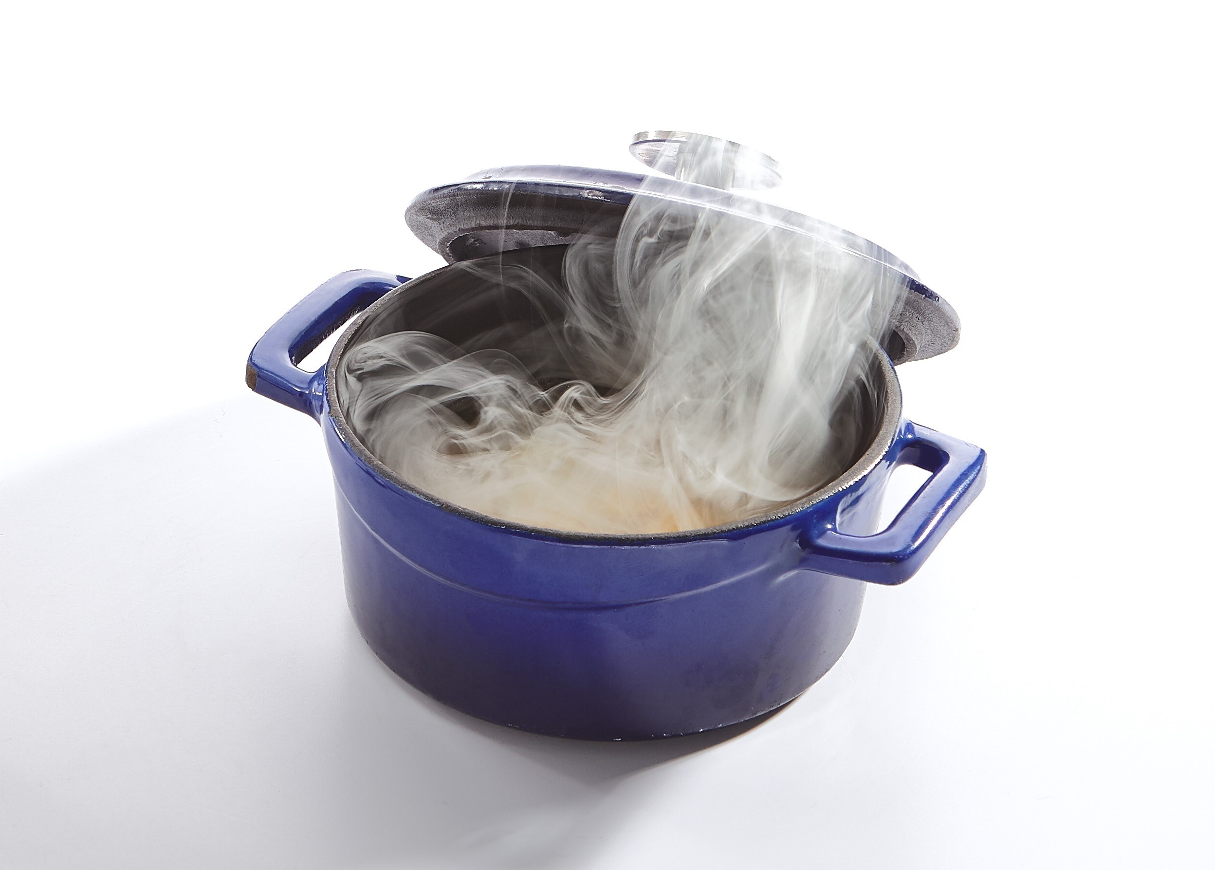 Steam is escaping soup that is boiling in a large pot.