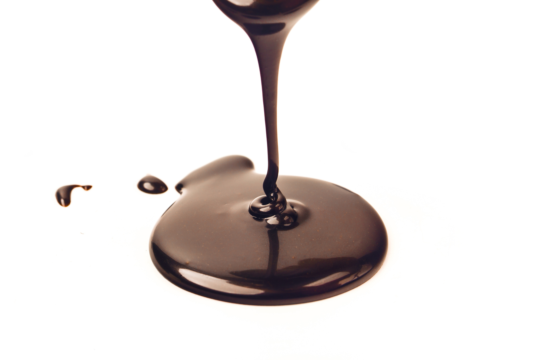 Flowing chocolate sauce has created a puddle.
